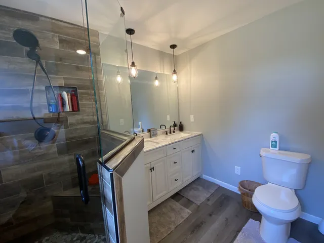 a view of empty room with wooden floor