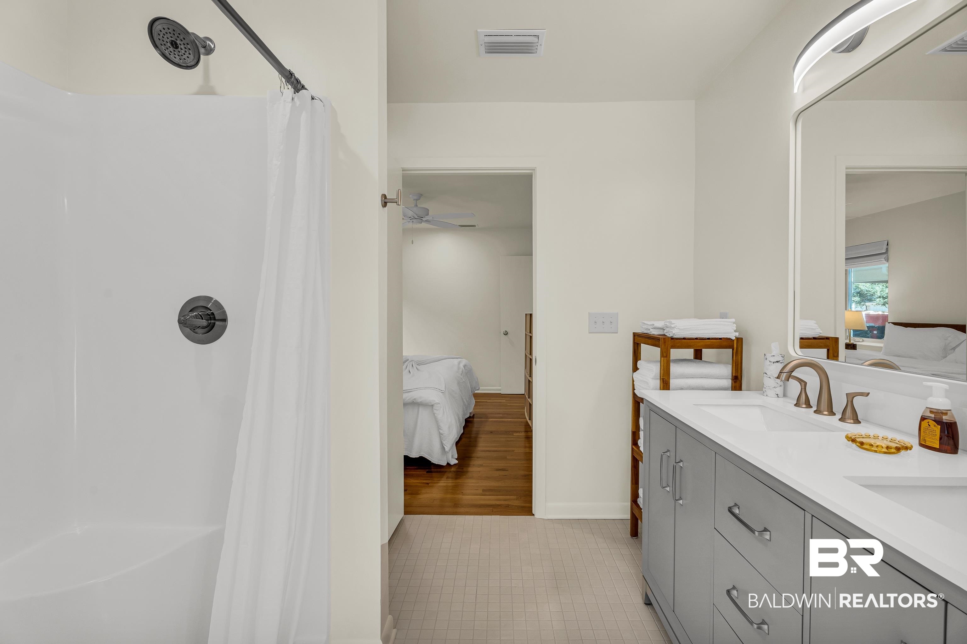 357 Azalea Street Fairhope, AL 36532 - Photo 11 of 22 Full bath with ensuite bath, double vanity, curtained shower, and light tile patterned floors