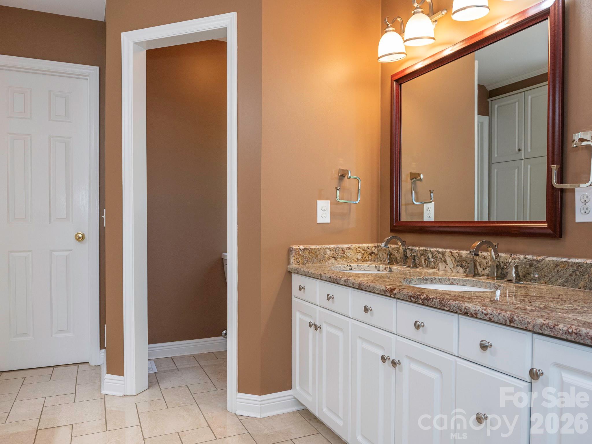 4440 Hucks Road Charlotte, NC 28269 - Photo 21 of 45 a bathroom with a granite countertop sink and a mirror
