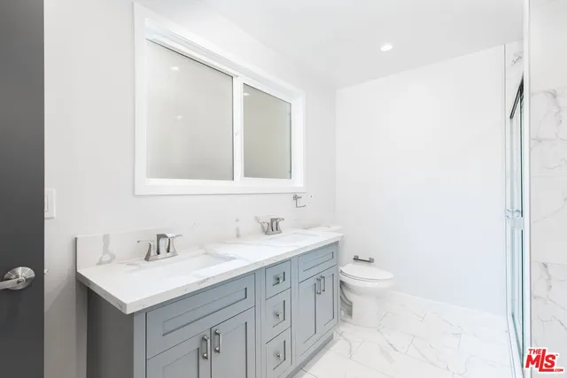 a bathroom with a sink toilet and a mirror