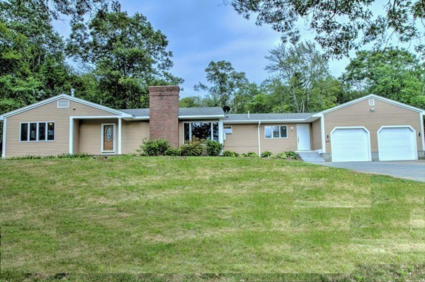 23 Hunt Road Westford, MA 01886 - Photo 1 of 27 a front view of a house with a garden