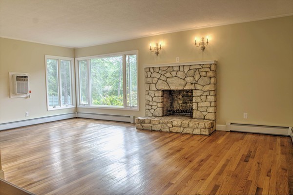 23 Hunt Road Westford, MA 01886 - Photo 13 of 27 an empty room with wooden floor fireplace and windows