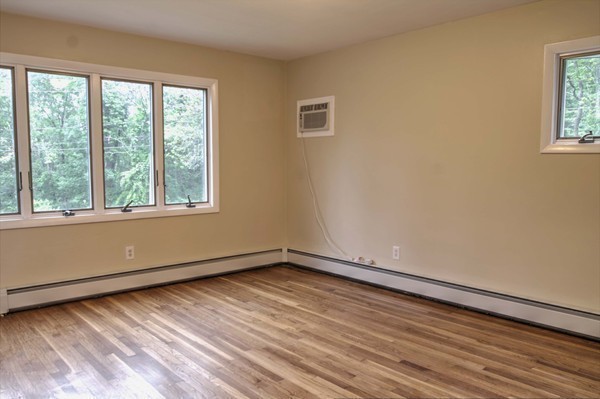 23 Hunt Road Westford, MA 01886 - Photo 20 of 27 a view of an empty room with wooden floor and a window
