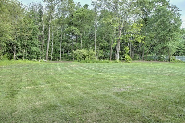 23 Hunt Road Westford, MA 01886 - Photo 26 of 27 a grassy field with trees in the background