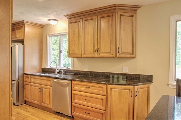 23 Hunt Road Westford, MA 01886 - Photo 5 of 27 a kitchen with granite countertop cabinets stainless steel appliances a sink and a window