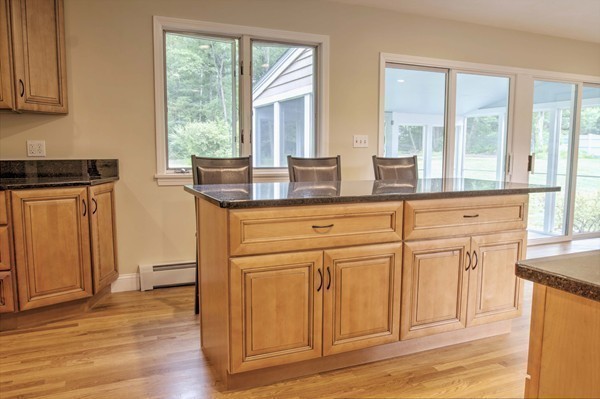 23 Hunt Road Westford, MA 01886 - Photo 6 of 27 a kitchen with stainless steel appliances granite countertop a stove a sink and a refrigerator with wooden floors
