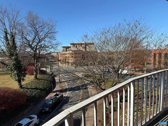 a view of a balcony with trees
