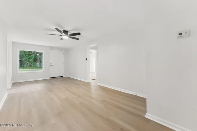 a view of an empty room with a window
