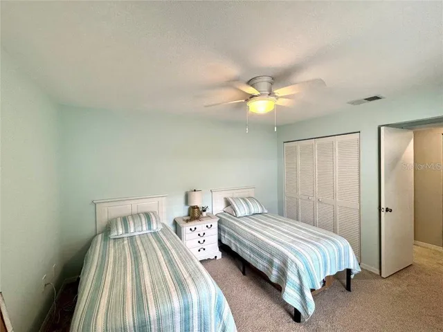 a view of a room with wooden floor and a floor to ceiling window