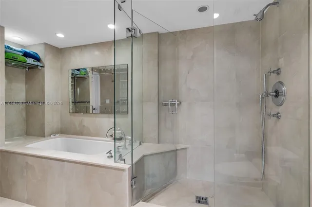 a bathroom with a bathtub and a shower