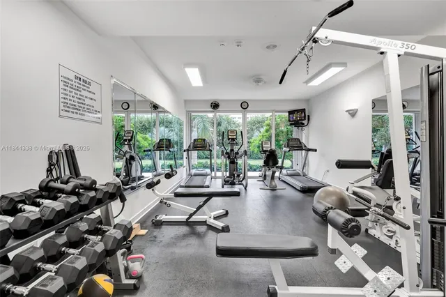a room with gym equipment and a large window