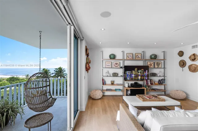 a living room with furniture and a book shelf