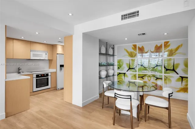 a kitchen with a table and chairs in it