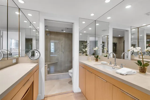 a bathroom with a sink double vanity and a shower