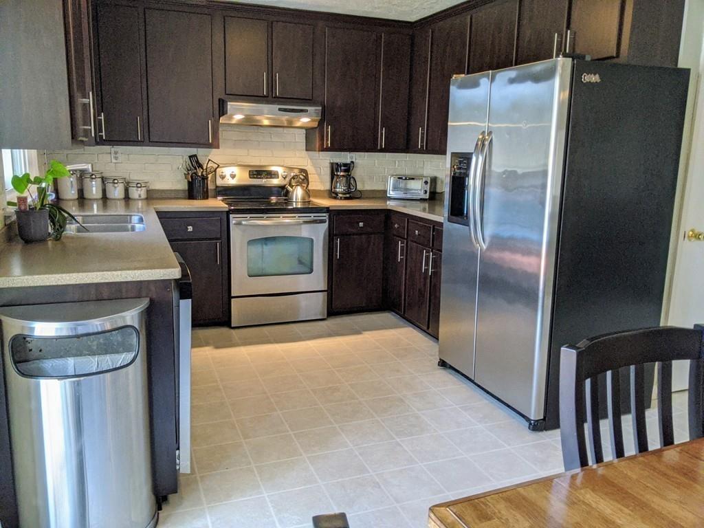 49 Ramshorn Road Charlton, MA 01507 - Photo 8 of 31 a kitchen with stainless steel appliances granite countertop a refrigerator sink and stove