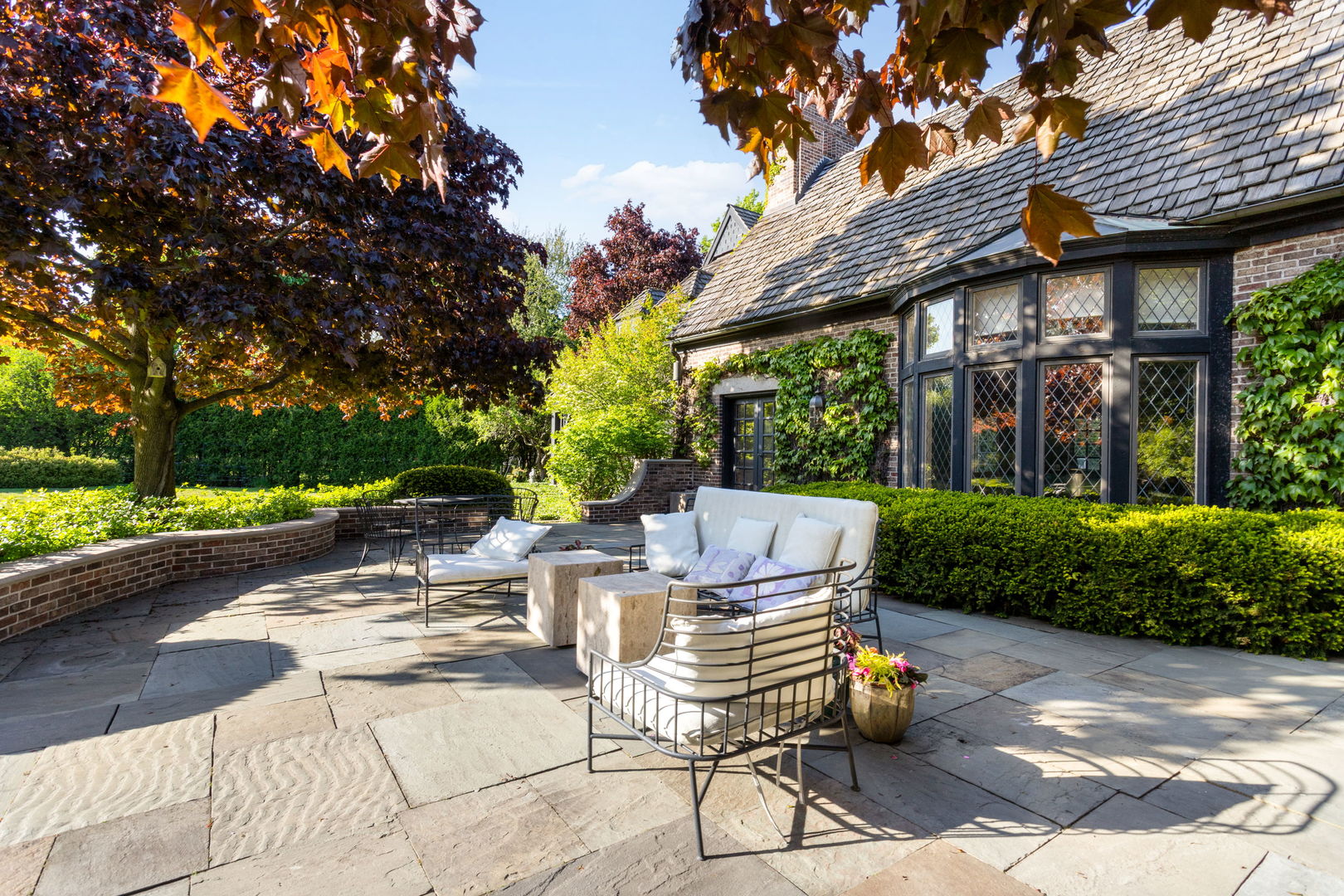 1490 Lake Road Lake Forest, IL 60045 - Photo 34 of 44 a view of a patio with table and chairs potted plants and a large tree