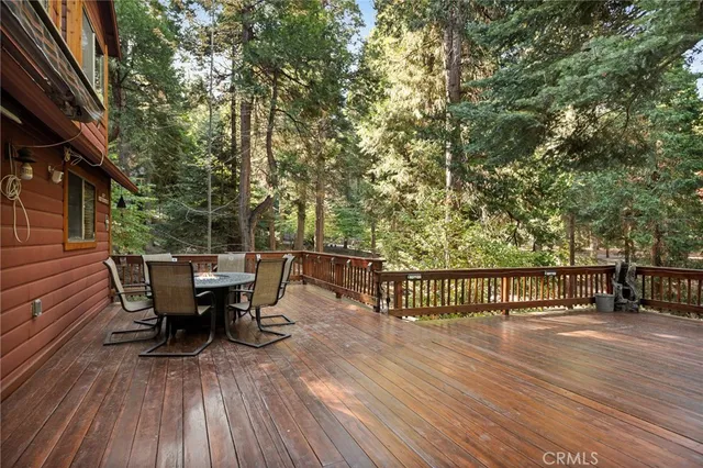 a view of a patio with table and chairs and wooden floor