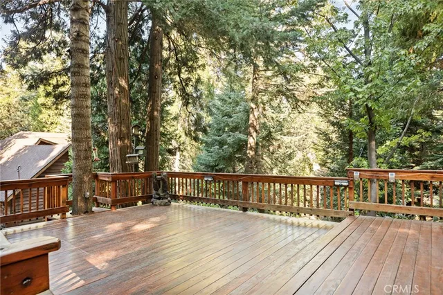 a view of a house with deck and wooden floor