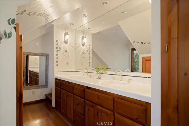 a bathroom with a sink double vanity granite and a mirror