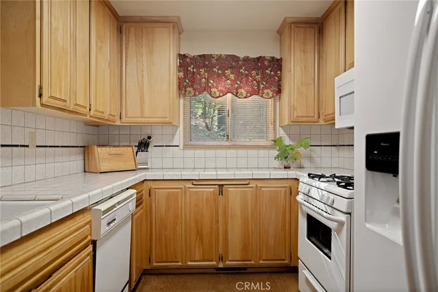 a kitchen with granite countertop a stove and a sink