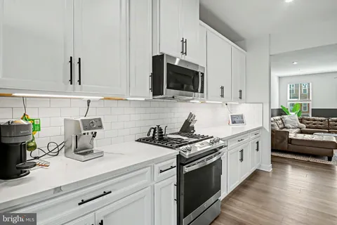 a kitchen with cabinets a sink and appliances