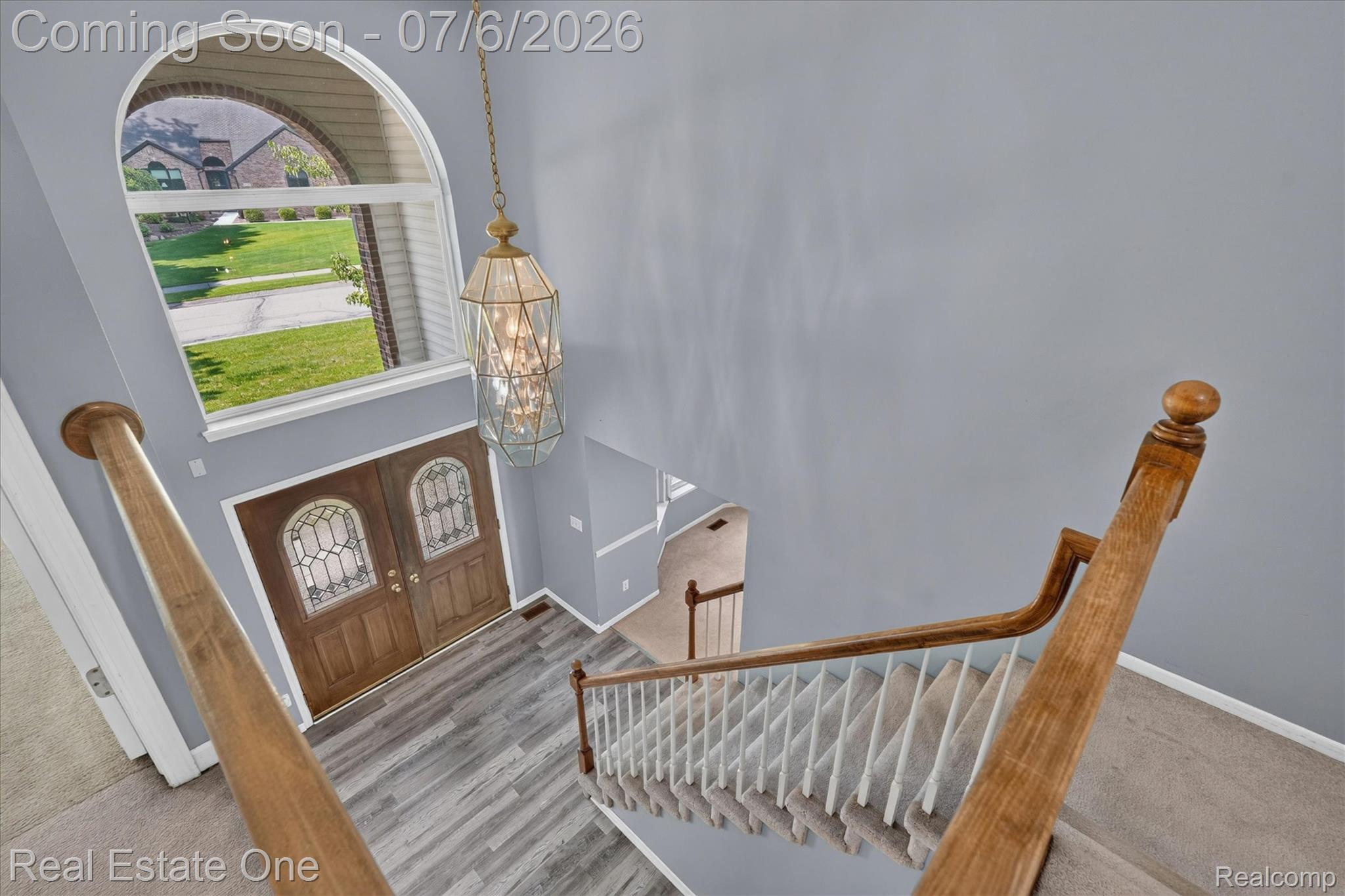 9610 Forest Ridge Drive Clarkston, MI 48348 - Photo 28 of 77 A dramatic two-story foyer makes a lasting first impression, anchored by a timeless chandelier. Above the entry, an expansive picture window floods the space with natural light, enhancing the home’s bright and airy feel.