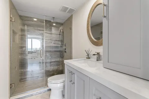 a bathroom with a sink a toilet and shower