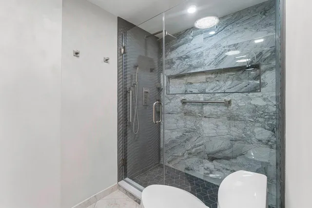 a bathroom with a toilet and a shower