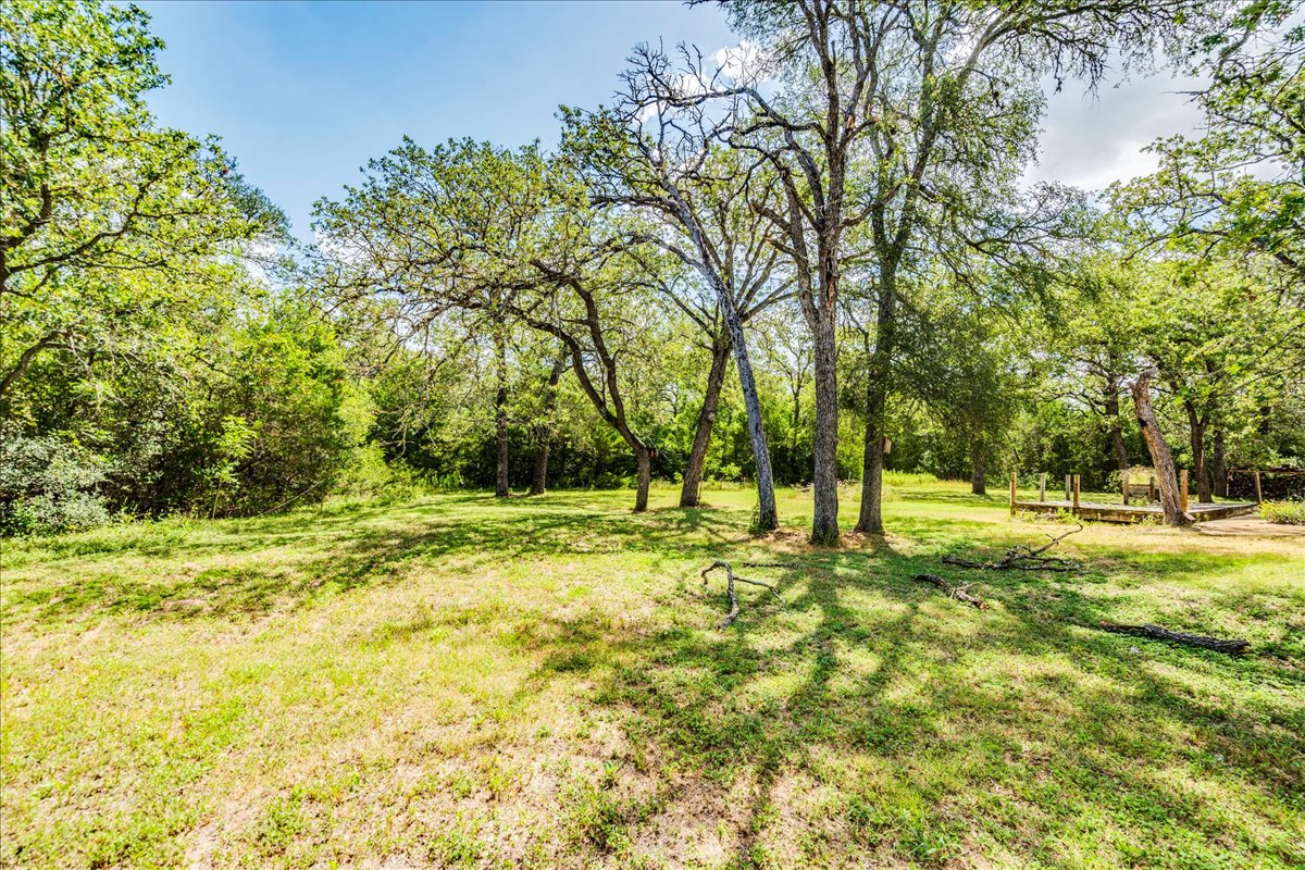 19106 Eyerley Road Manor, TX 78653 - Photo 29 of 40 A tranquil clearing with mature trees offers a peaceful escape.