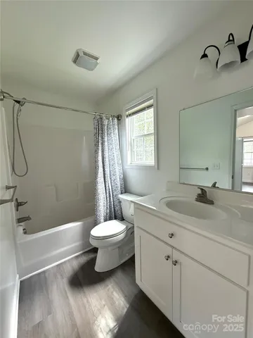 a bathroom with a double vanity sink toilet and shower