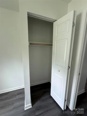 a view of walk in closet with wooden floor