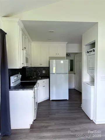 a kitchen with stainless steel appliances a refrigerator sink and white cabinets