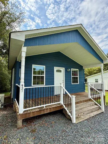 a view of a house with a yard and deck