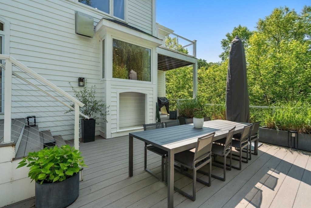 69 Princeton Road Brookline, MA 02467 - Photo 11 of 28 a view of a patio with table and chairs and potted plants