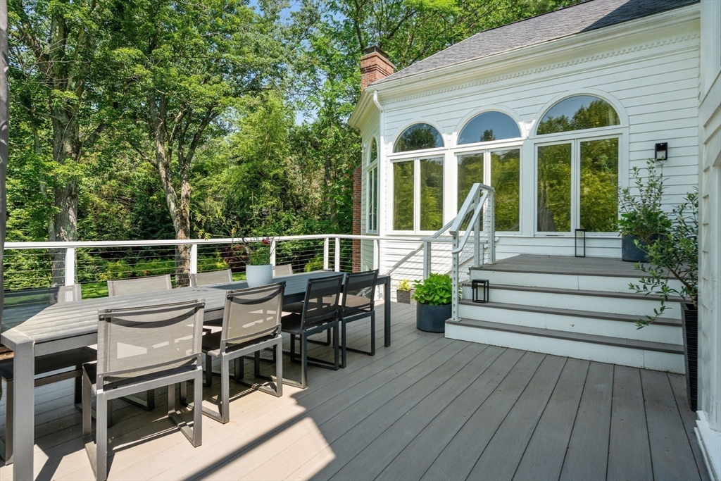 69 Princeton Road Brookline, MA 02467 - Photo 12 of 28 a view of a house with wooden deck and furniture