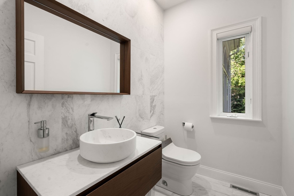 69 Princeton Road Brookline, MA 02467 - Photo 16 of 28 a bathroom with a toilet a sink and mirror
