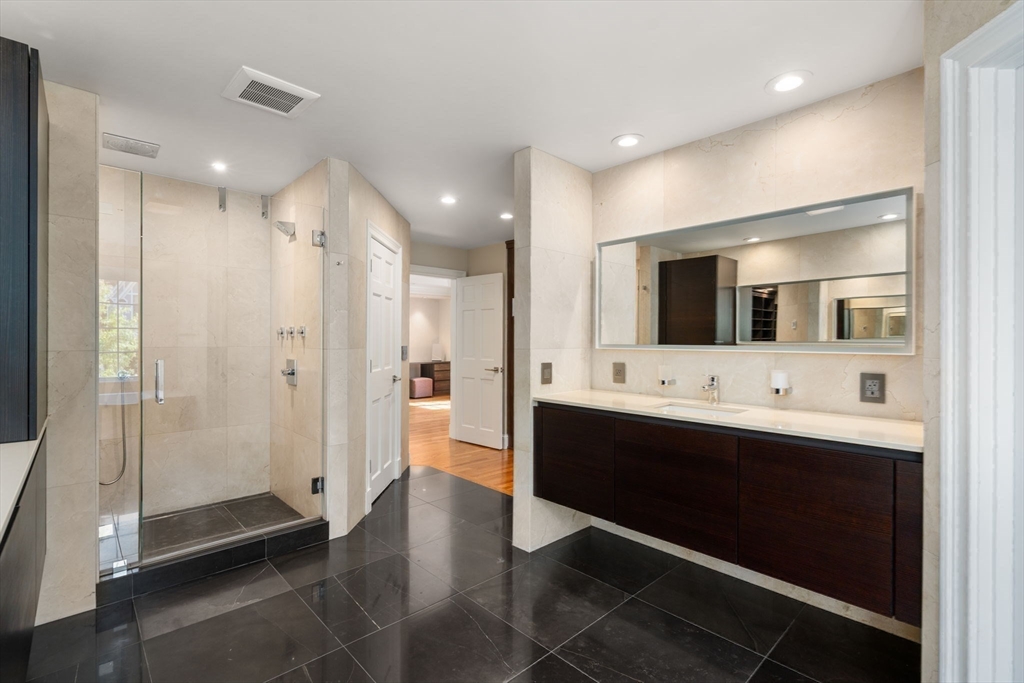 69 Princeton Road Brookline, MA 02467 - Photo 19 of 28 a bathroom with a double vanity sink mirror and shower