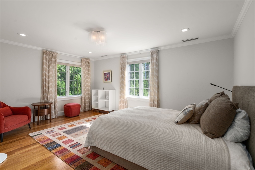 69 Princeton Road Brookline, MA 02467 - Photo 21 of 28 a bedroom with a large bed and wooden floor