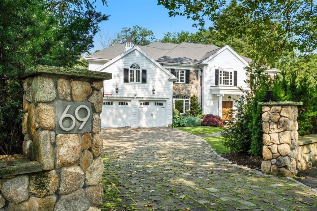 69 Princeton Road Brookline, MA 02467 - Photo 3 of 28 a view of a white house next to a yard with wooden fence