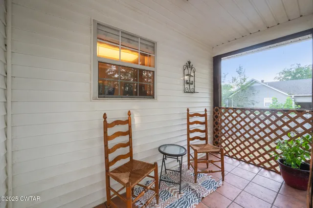 a view of a chairs and table in a balcony