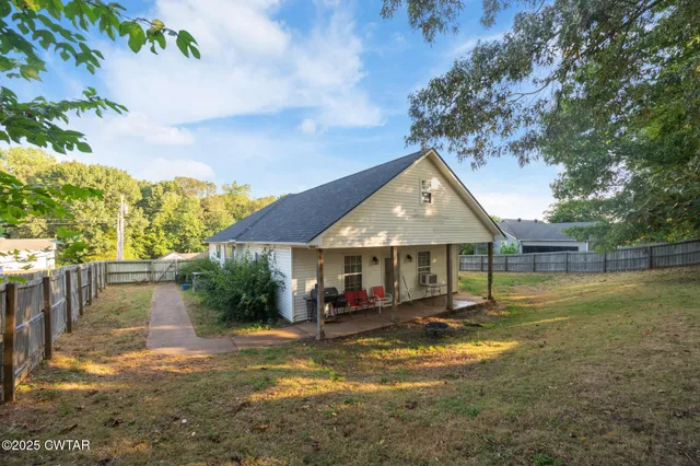 a view of a house with swimming pool and a yard
