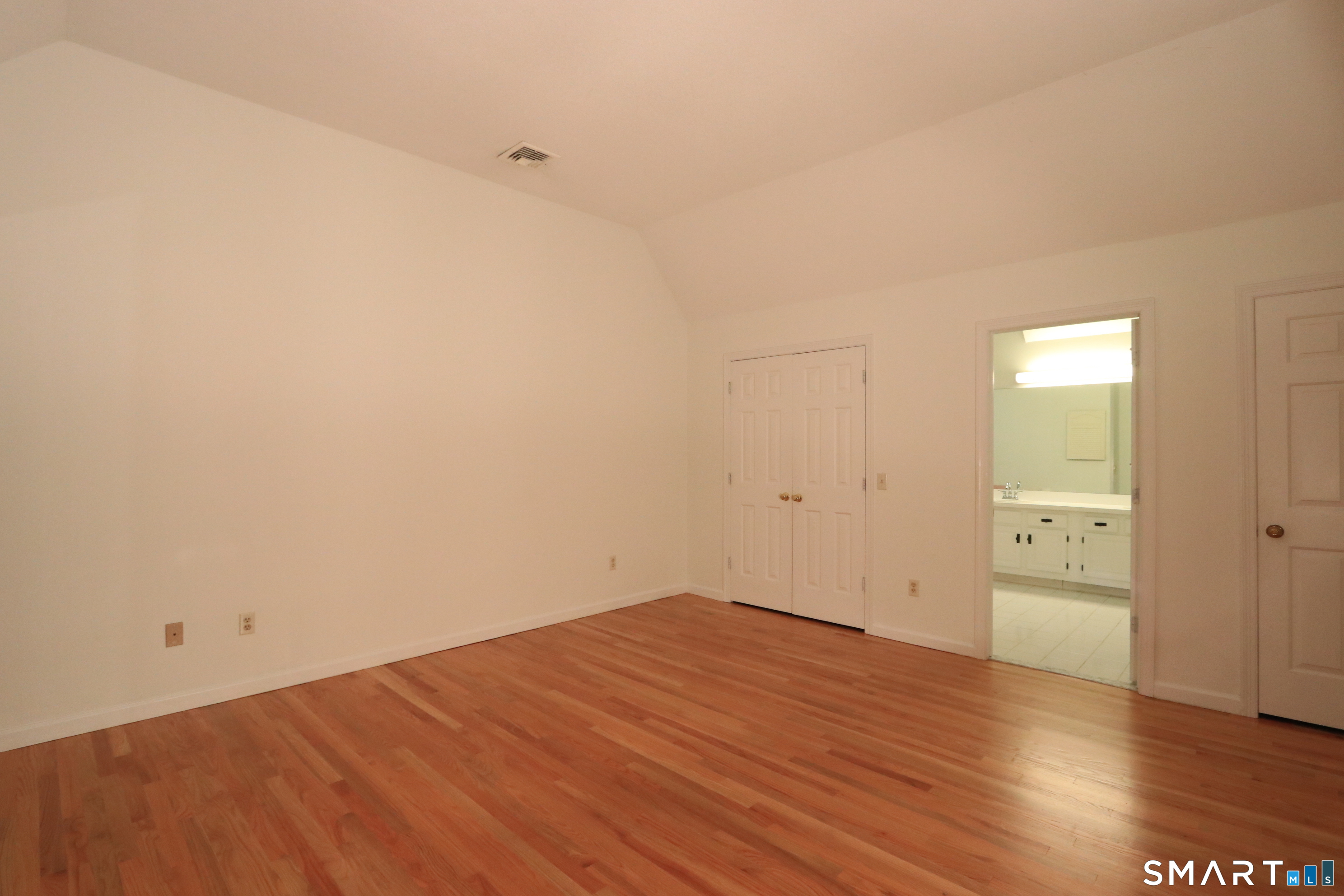 50 Wilton Crest Road, Unit 50 Wilton, CT 06897 - Photo 11 of 31 Primary bedroom with high ceiling and new hardwood floors