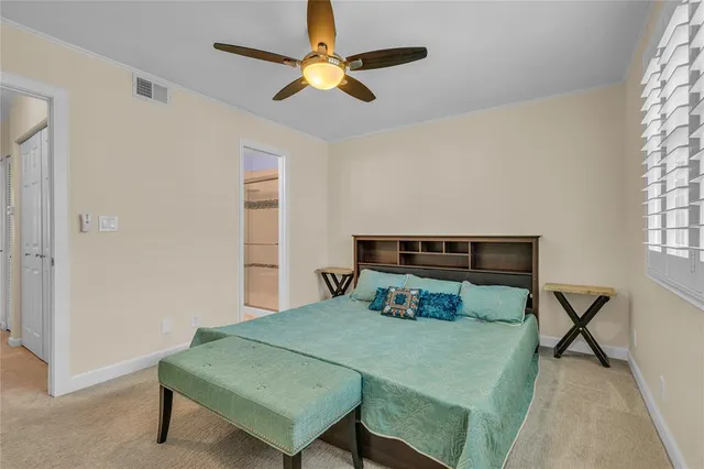 a bedroom with a bed a window and a chandelier