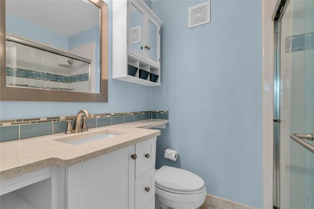 a bathroom with a shower and a toilet