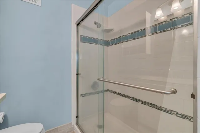 an empty room with a chandelier fan