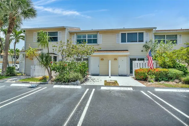 a front view of a house with a yard and a garage