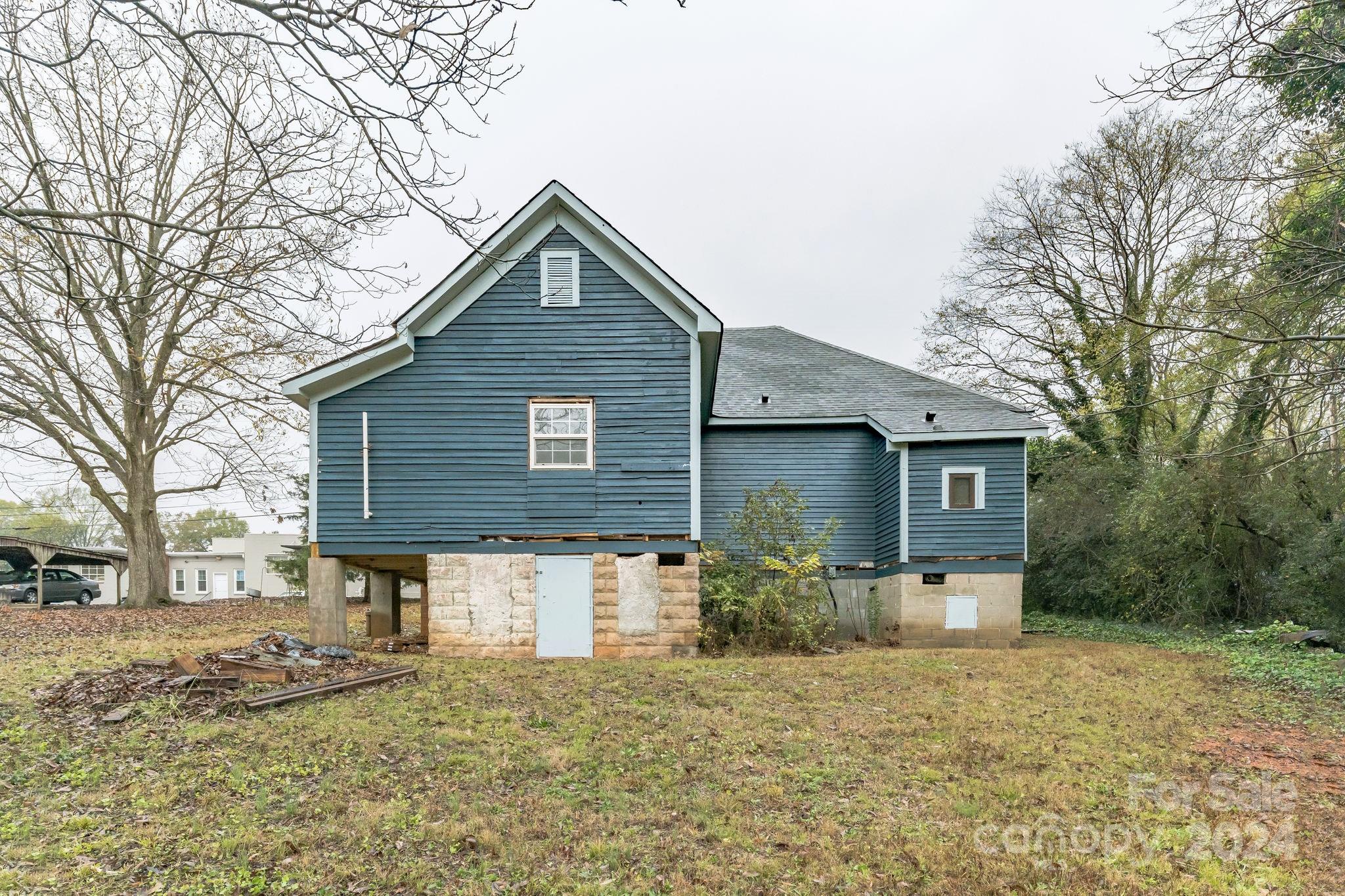 1119 Poplar Street Albemarle, NC 28001 - Photo 2 of 11 a front view of a house with a yard and garage