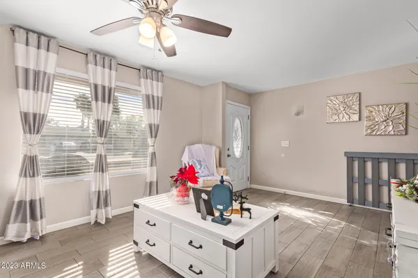 a view of dining room and chandelier fan and windows