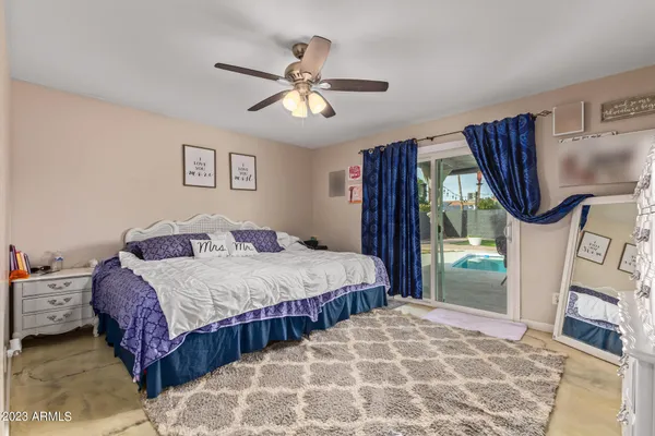 a bedroom with a bed mirror and a window