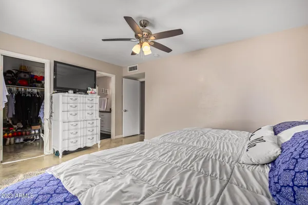 a bedroom with a bed and a walk in closet